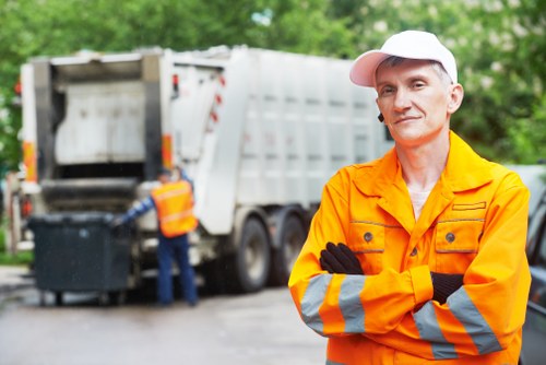 Operators handling waste containers and segregating recyclable materials